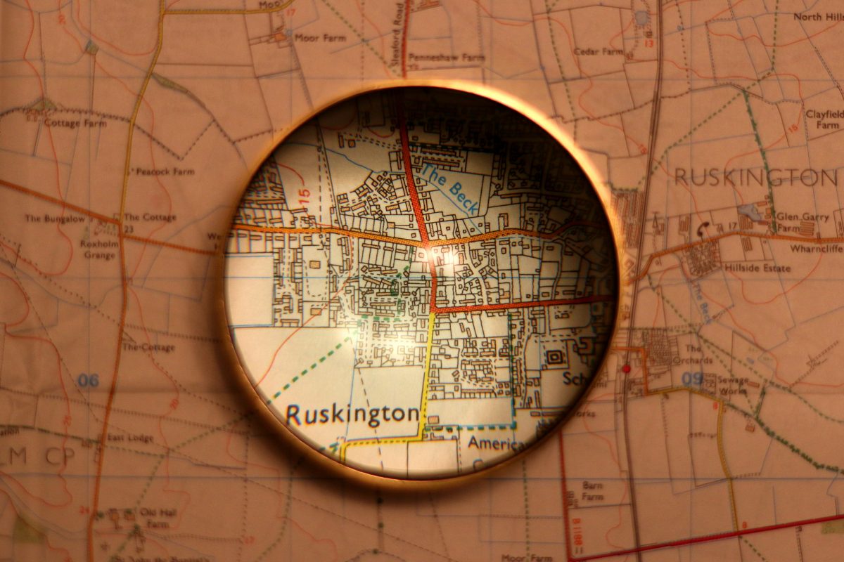 magnifying glass on map by Kevin Doncaster